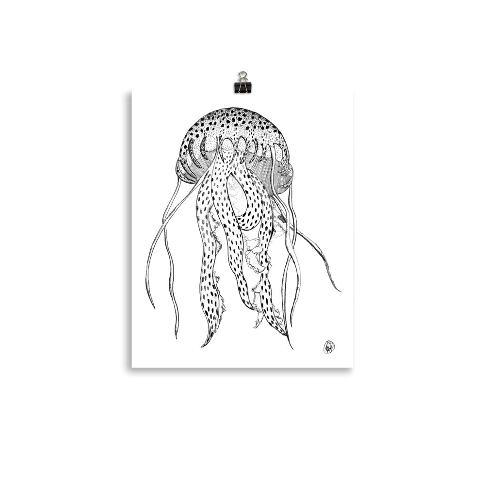 A black and white line art print of a jellyfish, shown hanging from a small black binder clip against a clean white background.