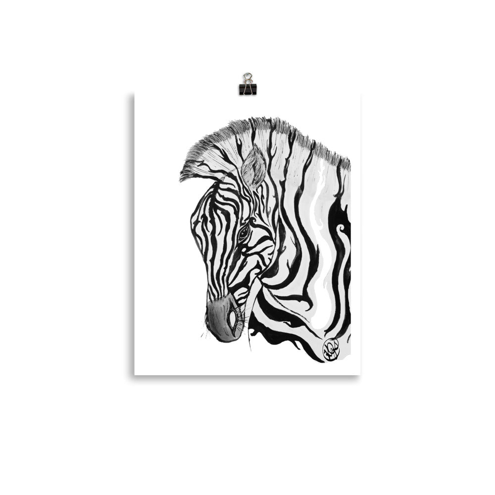 A black and white zebra head art print clipped at the top with a small black binder clip against a white background.