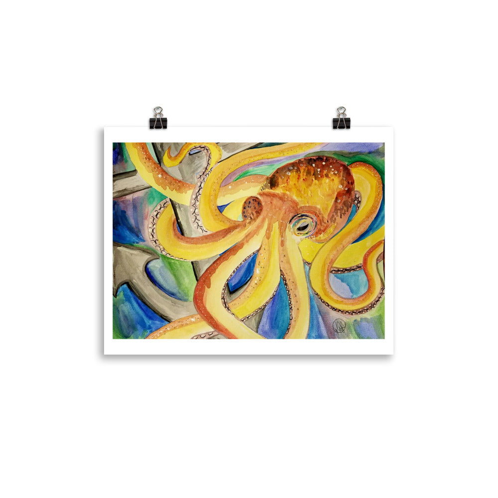 A square art print featuring a colorful watercolor painting of an octopus wrapping around an anchor, displayed with two black binder clips against a solid white background.