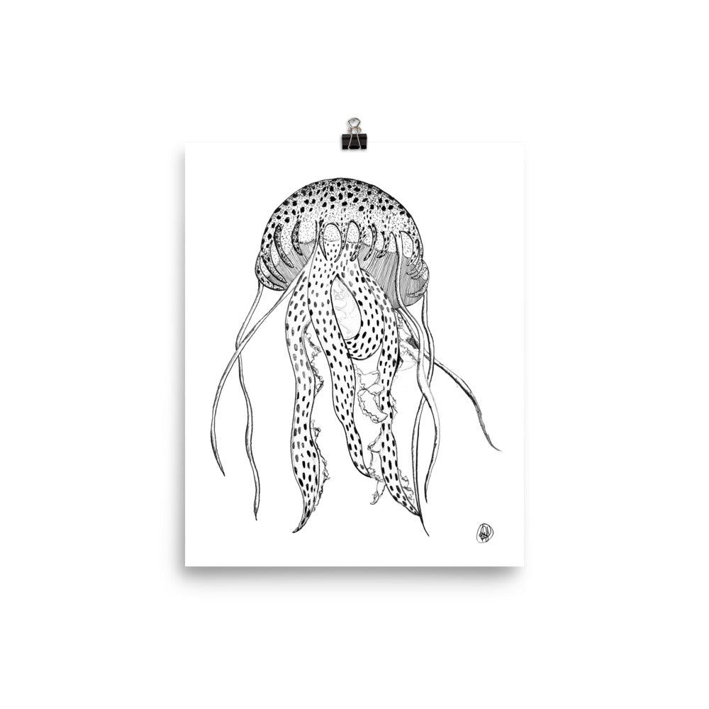 A black and white line art print of a jellyfish, shown hanging from a black binder clip against a clean white background.